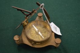 A brass compass.
