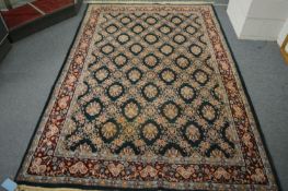 A Persian design rug, green ground with floral decoration, 260cm x 180cm.