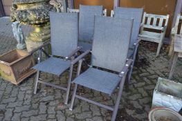 Four folding garden chairs.