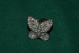 A heavy silver butterfly ring.