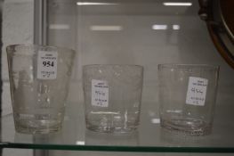 An 18th century tumbler engraved with a hunting scene and two other tumblers.