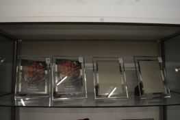 Four glass photograph frames.