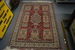 A machine made Persian style rug, 185cm x 122cm.