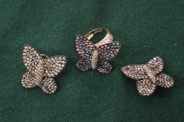A pair of silver butterfly earrings and ring.