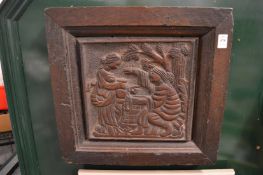 An early carved wood panel depicting figures at a well.