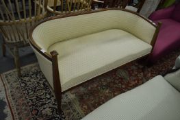 An Edwardian mahogany framed and upholstered settee.