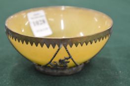 An unusual stone circular bowl with metal mounts.