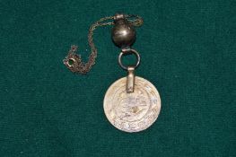 A coin set pendant and chain.