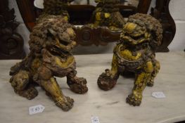 A pair of heavy cast metal Chinese lions.