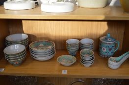 A quantity of Chinese famille jaune tea bowls and other items.