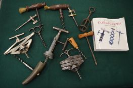 A collection of corkscrews and a corkscrew collecting book.