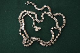 A long diamante necklace.