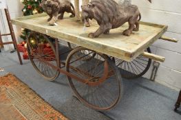 A large hand cart, the rectangular top supported on wrought iron frame with four wire spoked