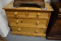 A pine chest of drawers.