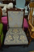 A Victorian walnut framed upholstered chair.