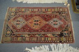 A small Persian rug, 135cm x 80cm.