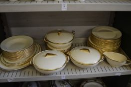 Quantity of stylish cream dinnerware with gilt and green decorated borders.