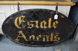 An old wrought iron double sided hanging Estate Agents sign.