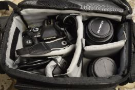 An Olympus E500 camera with accessories and bag.