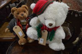 A White Christmas bear wearing a wooly hat and scarf together with a Swiss bear smoking a pipe.