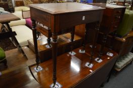 A 19th century mahogany occasional table with turned legs and brass castors.