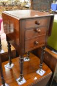 A 19th century mahogany drop-flap bedside table with small drawer and chamber pot cupboard on turned