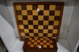 A mahogany folding travelling chess board with contents together with another chess board.