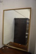 A wall mirror with decorative frame.