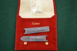 A Cartier leather watch strap in suede pouch.