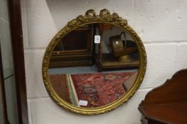 A circular gilt framed wall mirror.