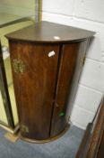 A 19th century oak bow front hanging corner cupboard.