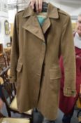 A ladies Operations trench coat, Barbour hats, scarfs etc.