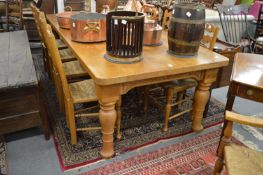 A very good heavy oak rectangular dining table with plank top, acorn and oak leaf carved frieze on