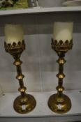 A pair of large brass ecclesiastical style candlesticks.