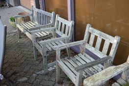 A pair of hardwood garden armchairs and similar bench.