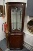 A reproduction standing corner cabinet.