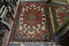 A Persian rug, red ground with stylised decoration, 143cm x 102cm.