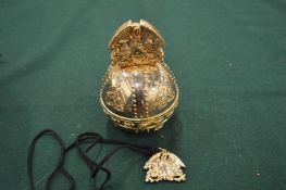 An unusual gilt metal orb, boxed.