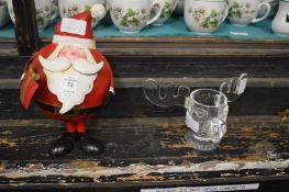 A wobbly santa and a Warner Brothers glass stags head tea light holder.