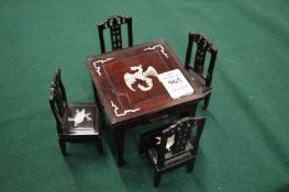 Miniature Chinese hardwood table and four chairs.