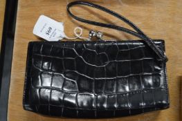 A Burberry black leather purse.