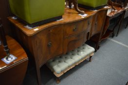 A reproduction mahogany serpentine fronted sideboard.