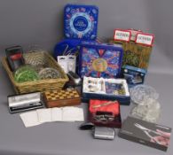 Collection of items including tins, wooden travel chess set, Sea Gems pens in the style of Charles