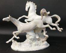 Large Lladro galloping horses figurine on naturalistic base, impressed mark to base, approx. 37cm