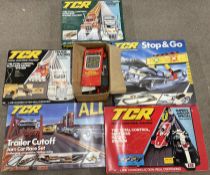Five TCR boxed car/truck racing games plus some spares