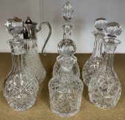 Pair of crystal decanters (one with chip), three other decanters & a claret jug