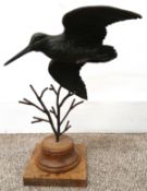 Bronze Snipe in flight on wooden stand, with indistinct signature, 32cm high