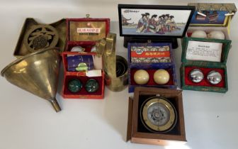 5 boxed pairs of Chinese therapy balls, brass measuring cups with Chinese design to handle,