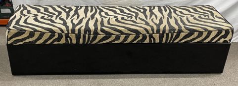 Low level sofa stool with a zebra skin print cushion top (183cm long), 3 leather & lacquer covered