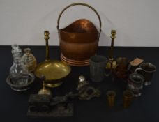 Various brass and metal ware including a coal scuttle, measuring cups, Oriental dragon, candlesticks